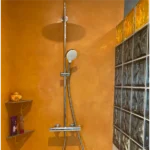 Salle de bain moderne en béton ciré teinte abricot, finition Rouvière Collection.